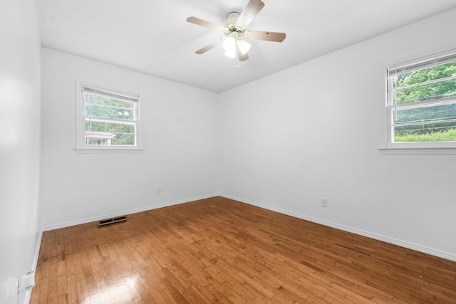 1541 E Crestview St, Springfield, MO 65804 - empty room with healthy amount of natural light, light wood finished floors, and ceiling fan