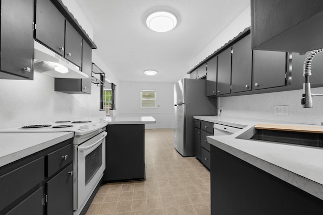 1541 E Crestview St, Springfield, MO 65804 - kitchen with white electric range oven, under cabinet range hood, light countertops, freestanding refrigerator, and dark cabinetry