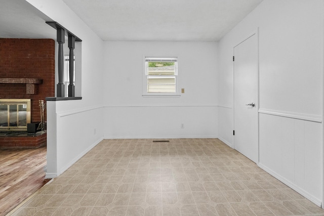 1541 E Crestview St, Springfield, MO 65804 - spare room featuring a fireplace and baseboards