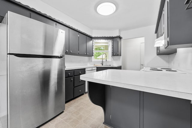 1541 E Crestview St, Springfield, MO 65804 - kitchen featuring freestanding refrigerator, a peninsula, light countertops, light floors, and under cabinet range hood