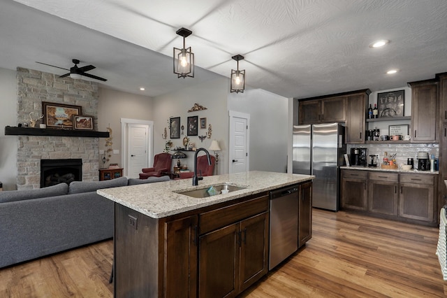 2060 Buckhorn Rd, Ozark, MO 65721 - kitchen featuring stainless steel appliances, dark brown cabinets, light wood-type flooring, open floor plan, and recessed lighting