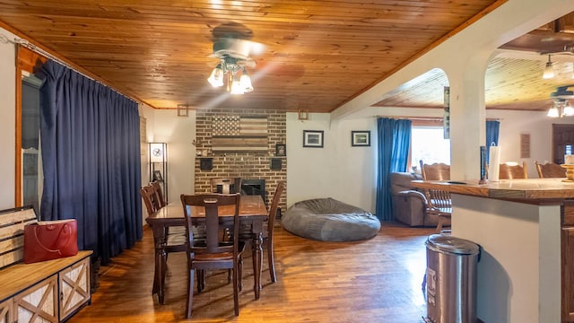 1160 Bethel Ave, Mammoth Spring, AR 72554 - dining space with a ceiling fan, wooden ceiling, wood finished floors, and a fireplace