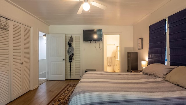1160 Bethel Ave, Mammoth Spring, AR 72554 - bedroom featuring two closets, wood finished floors, ornamental molding, connected bathroom, and a ceiling fan