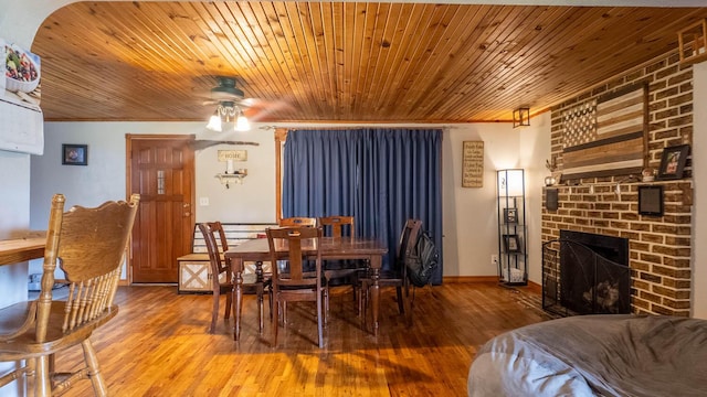 1160 Bethel Ave, Mammoth Spring, AR 72554 - dining space with a ceiling fan, hardwood / wood-style flooring, a fireplace, and wooden ceiling