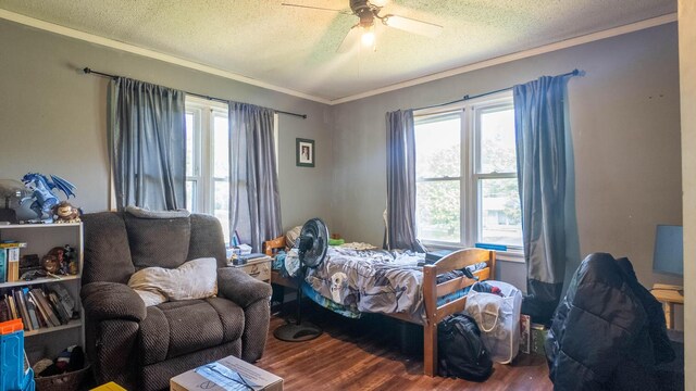 1160 Bethel Ave, Mammoth Spring, AR 72554 - bedroom with wood finished floors, crown molding, multiple windows, a textured ceiling, and ceiling fan