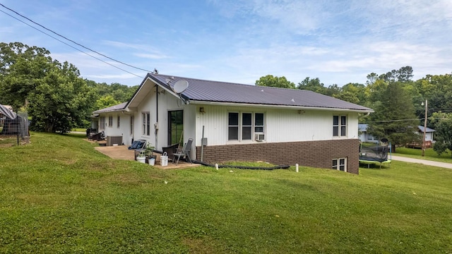 1160 Bethel Ave, Mammoth Spring, AR 72554 - view of home's exterior featuring a trampoline, brick siding, a patio, and a yard
