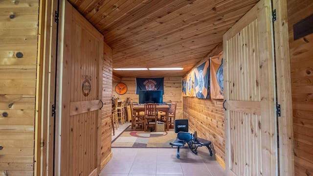 1160 Bethel Ave, Mammoth Spring, AR 72554 - hallway with wood walls, wooden ceiling, and tile patterned floors
