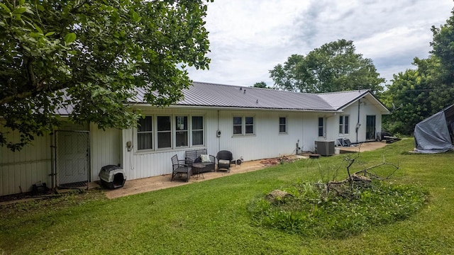 1160 Bethel Ave, Mammoth Spring, AR 72554 - back of house featuring a lawn, a metal roof, and a patio area