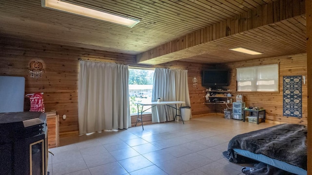 1160 Bethel Ave, Mammoth Spring, AR 72554 - tiled bedroom with wood walls and a wood stove