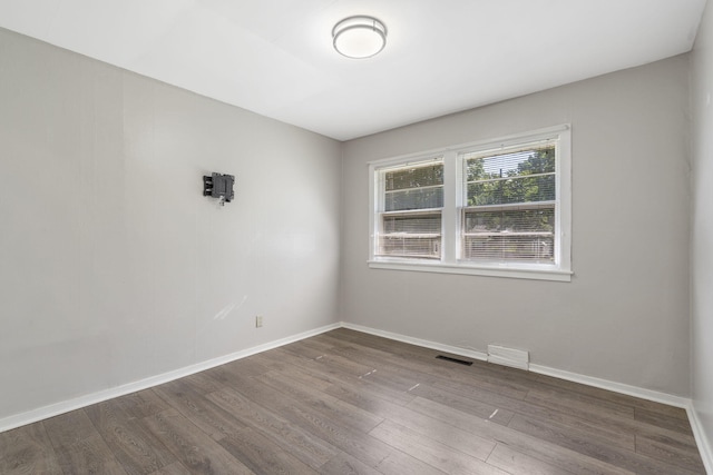 1547 S Kickapoo Ave, Springfield, MO 65804 - empty room featuring dark wood-style floors and baseboards