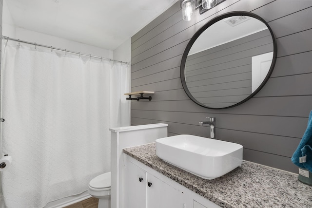 1547 S Kickapoo Ave, Springfield, MO 65804 - bathroom featuring vanity and wood walls