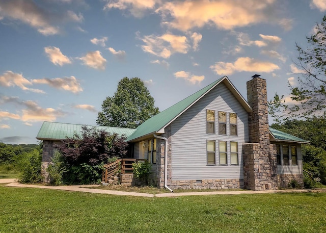 4534 Bayou Access Rd, Mammoth Spring, AR 72554 - view of property exterior featuring a lawn, a metal roof, a chimney, and crawl space