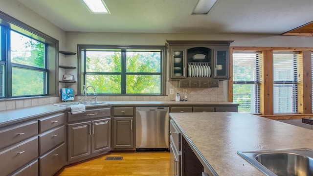 4534 Bayou Access Rd, Mammoth Spring, AR 72554 - kitchen with dishwasher, healthy amount of natural light, backsplash, and glass insert cabinets