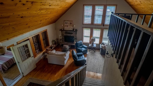 4534 Bayou Access Rd, Mammoth Spring, AR 72554 - living room with wood finished floors, lofted ceiling, a stone fireplace, and wooden ceiling