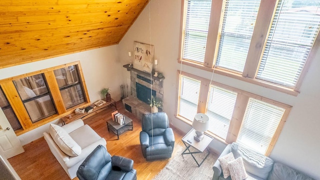 4534 Bayou Access Rd, Mammoth Spring, AR 72554 - living area with wood finished floors, lofted ceiling, and a fireplace with raised hearth