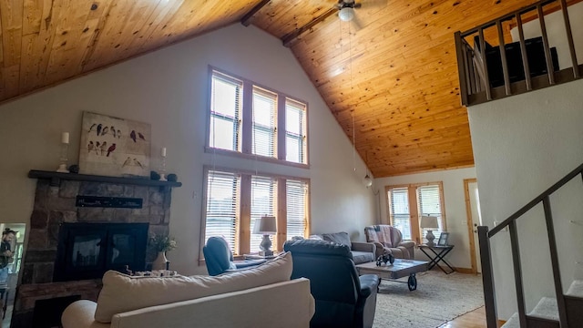 4534 Bayou Access Rd, Mammoth Spring, AR 72554 - living room featuring stairs, wood ceiling, a stone fireplace, high vaulted ceiling, and wood finished floors