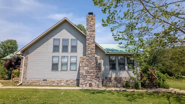 4534 Bayou Access Rd, Mammoth Spring, AR 72554 - view of side of home featuring a chimney, a lawn, stairs, and a metal roof