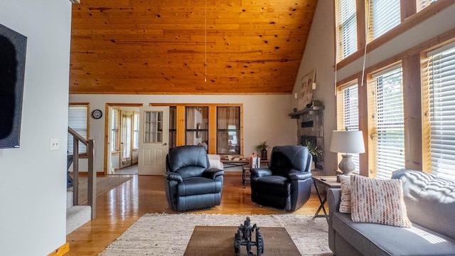 4534 Bayou Access Rd, Mammoth Spring, AR 72554 - living area featuring high vaulted ceiling, wood finished floors, a stone fireplace, stairway, and wooden ceiling