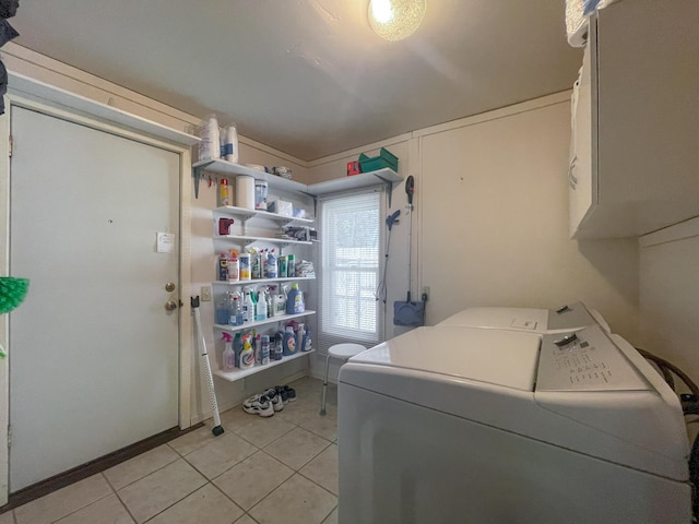 220 E Portland St, Springfield, MO 65807 - washroom with cabinet space, washer and clothes dryer, and light tile patterned floors