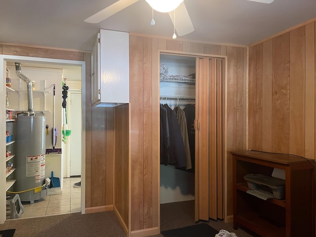 220 E Portland St, Springfield, MO 65807 - bedroom with water heater, wood walls, tile patterned floors, and a ceiling fan