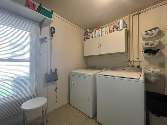 220 E Portland St, Springfield, MO 65807 - washroom with washing machine and dryer, cabinet space, and light tile patterned floors