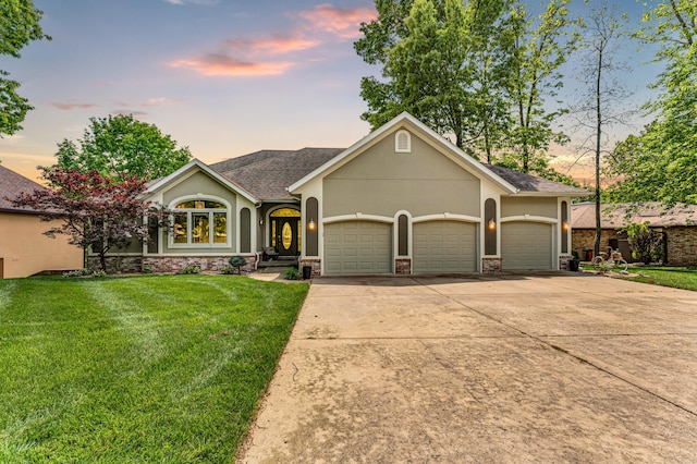 3318 Winged Foot Dr, Nixa, MO 65714 - view of front of home with a garage, a yard, stucco siding, and driveway