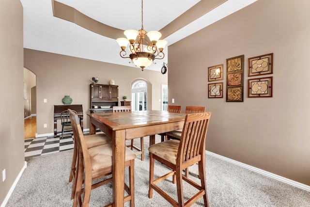 3318 Winged Foot Dr, Nixa, MO 65714 - carpeted dining room featuring arched walkways and a chandelier