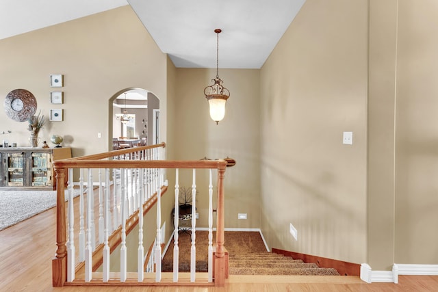 3318 Winged Foot Dr, Nixa, MO 65714 - stairway with arched walkways, a chandelier, and wood finished floors