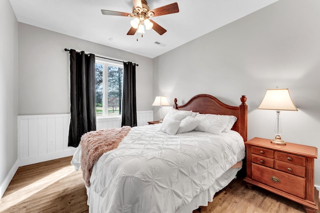 3318 Winged Foot Dr, Nixa, MO 65714 - bedroom featuring light wood finished floors, wainscoting, and a ceiling fan