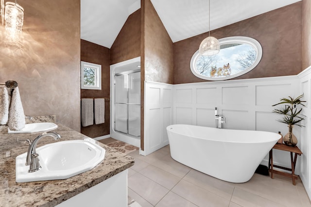 3318 Winged Foot Dr, Nixa, MO 65714 - bathroom with a decorative wall, a stall shower, a freestanding bath, vaulted ceiling, and double vanity