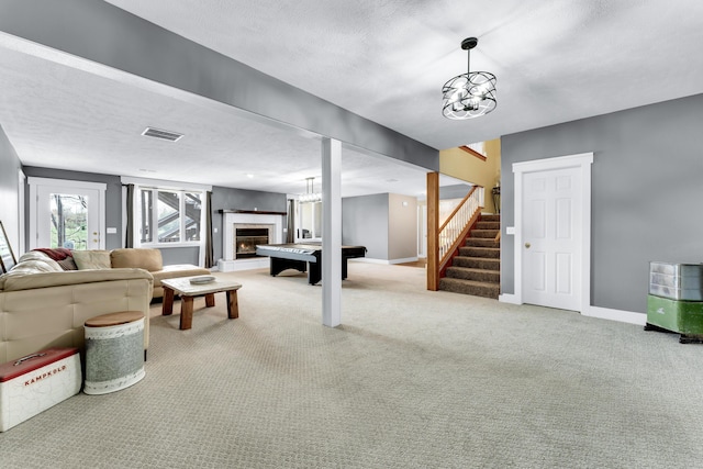 3318 Winged Foot Dr, Nixa, MO 65714 - living room featuring carpet floors, stairway, a lit fireplace, and heating unit