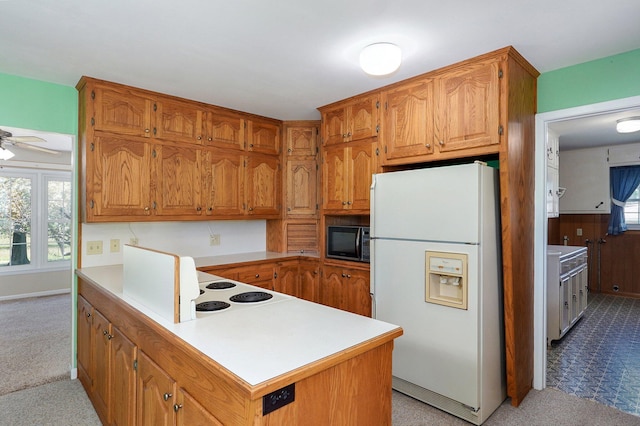 13762 State Highway Z, Verona, MO 65769 - kitchen with freestanding refrigerator, black microwave, light colored carpet, light countertops, and a peninsula