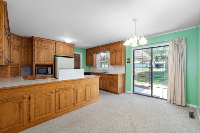 13762 State Highway Z, Verona, MO 65769 - kitchen with black microwave, freestanding refrigerator, light countertops, a chandelier, and a peninsula