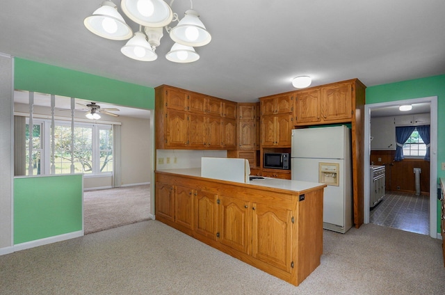 13762 State Highway Z, Verona, MO 65769 - kitchen with freestanding refrigerator, black microwave, light carpet, and a peninsula