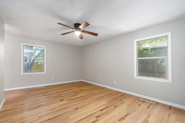 3656 S Kansas Ave, Springfield, MO 65807 - unfurnished room with light wood-style flooring, plenty of natural light, ceiling fan, and a textured ceiling