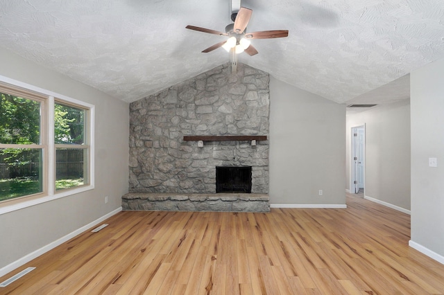 3656 S Kansas Ave, Springfield, MO 65807 - unfurnished living room featuring a ceiling fan, a fireplace, wood finished floors, a textured ceiling, and vaulted ceiling