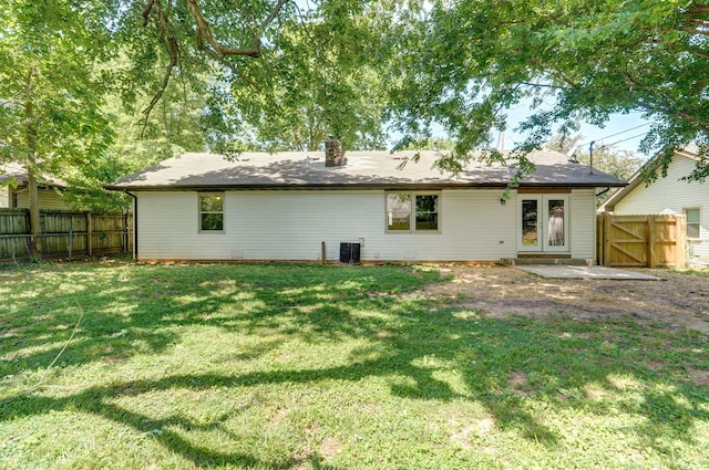 3656 S Kansas Ave, Springfield, MO 65807 - back of property featuring a fenced backyard and a chimney