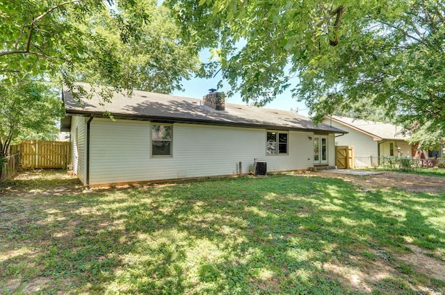 3656 S Kansas Ave, Springfield, MO 65807 - rear view of property with a chimney and a fenced backyard