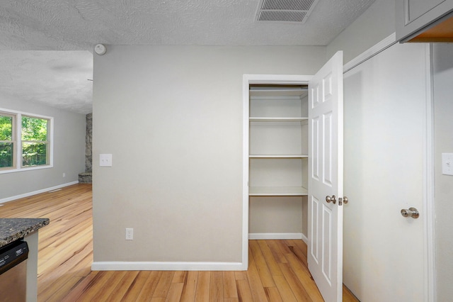3656 S Kansas Ave, Springfield, MO 65807 - hallway featuring light wood-style flooring and a textured ceiling