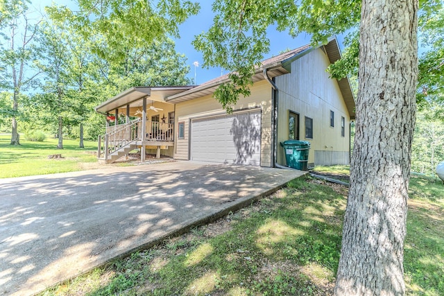 10675 State Highway Aa, Grovespring, MO 65662 - view of side of property featuring concrete driveway, an attached garage, stairs, a porch, and a lawn