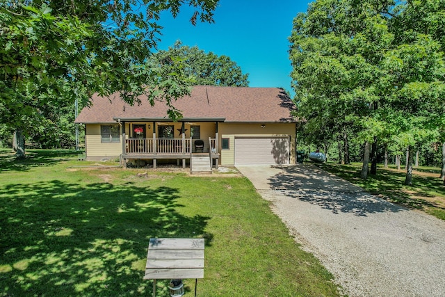 10675 State Highway Aa, Grovespring, MO 65662 - view of front of home with covered porch, an attached garage, a front lawn, driveway, and a shingled roof