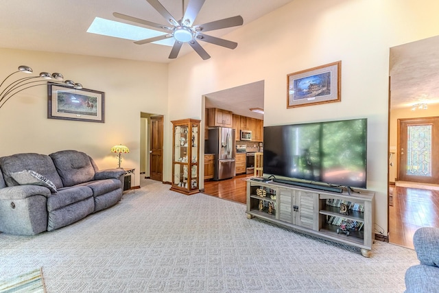 10675 State Highway Aa, Grovespring, MO 65662 - living room with a ceiling fan, a skylight, high vaulted ceiling, and wood finished floors