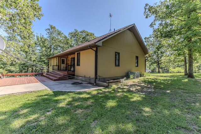 10675 State Highway Aa, Grovespring, MO 65662 - back of house featuring a deck, a patio, and a lawn
