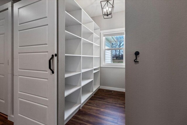 2803 Town Dr, Mountain Grove, MO 65711 - spacious closet with dark wood-type flooring and a chandelier