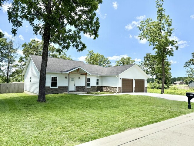 2803 Town Dr, Mountain Grove, MO 65711 - view of front of home featuring an attached garage, stone siding, concrete driveway, and a shingled roof