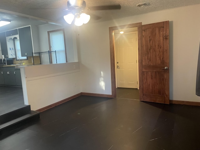 428 N Olive St, Marshfield, MO 65706 - unfurnished dining area with ceiling fan and a textured ceiling