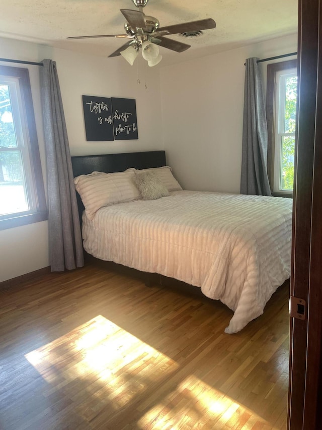428 N Olive St, Marshfield, MO 65706 - bedroom with wood finished floors and a ceiling fan