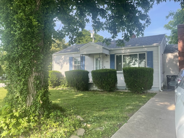 428 N Olive St, Marshfield, MO 65706 - view of front of house with a chimney, a front yard, and a shingled roof
