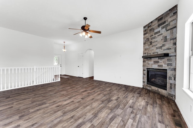 639 N Althea Ave, Nixa, MO 65714 - unfurnished living room featuring ceiling fan, wood finished floors, a fireplace, and arched walkways