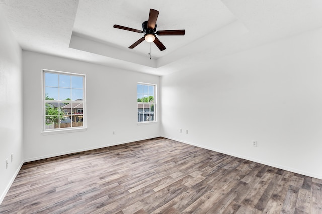 639 N Althea Ave, Nixa, MO 65714 - empty room featuring a raised ceiling, wood finished floors, and ceiling fan